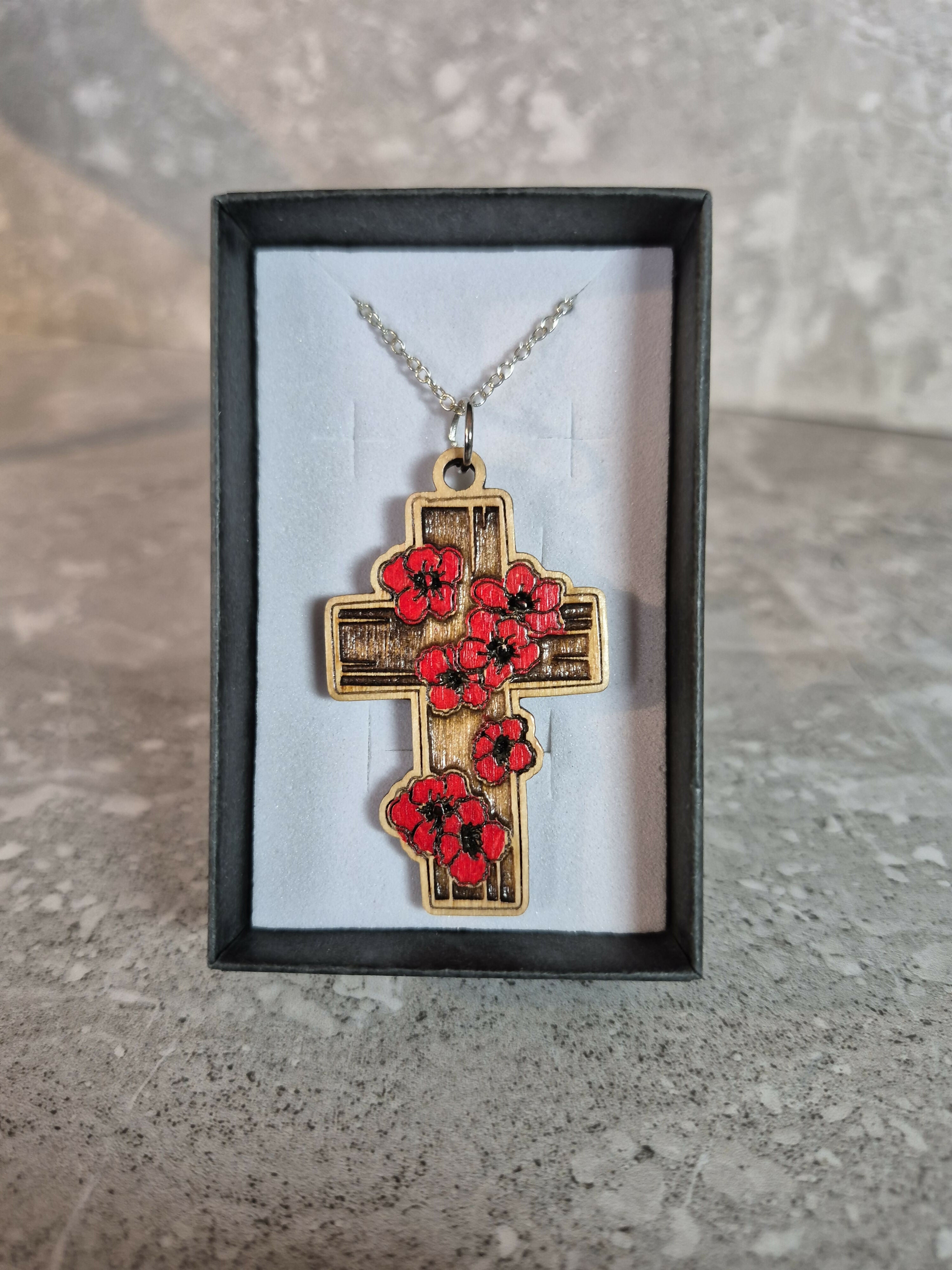 Handcrafted and engraved red poppy cross.