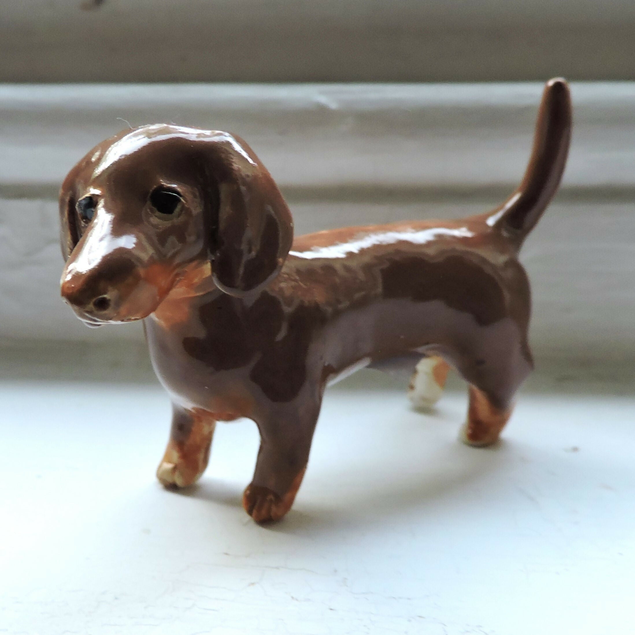 Ceramic Chocolate and tan dachshund dog sculpture