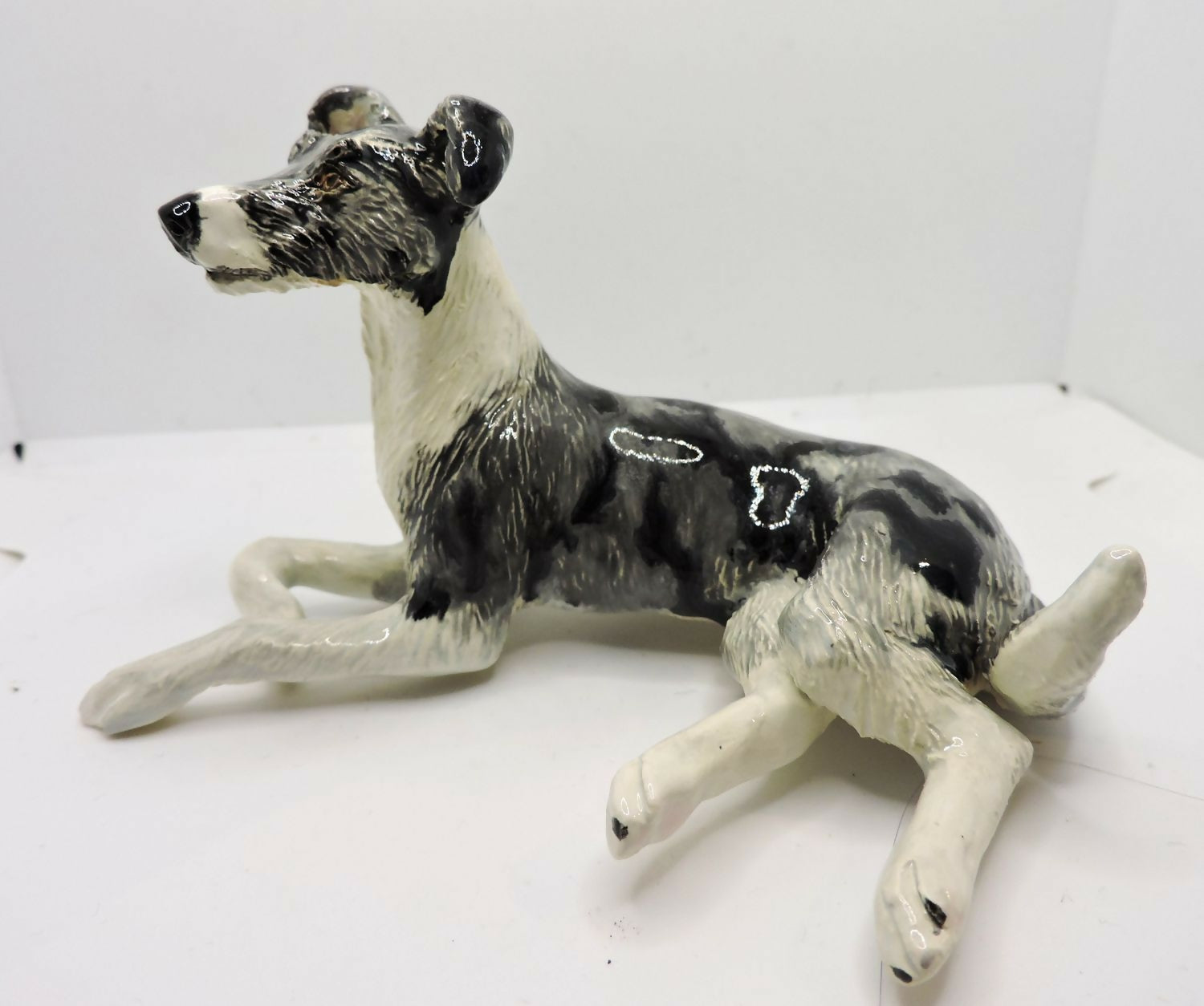 Ceramic Rough coated lurcher dog sculpture, merle