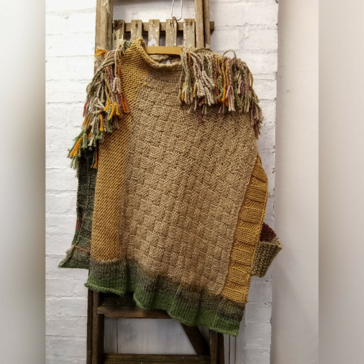 LENNON HAND KNITTED TABBARD WITH PLAITED FRINGING