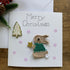 Christmas Card with Crocheted Rabbit Putting Star on the Christmas tree.
