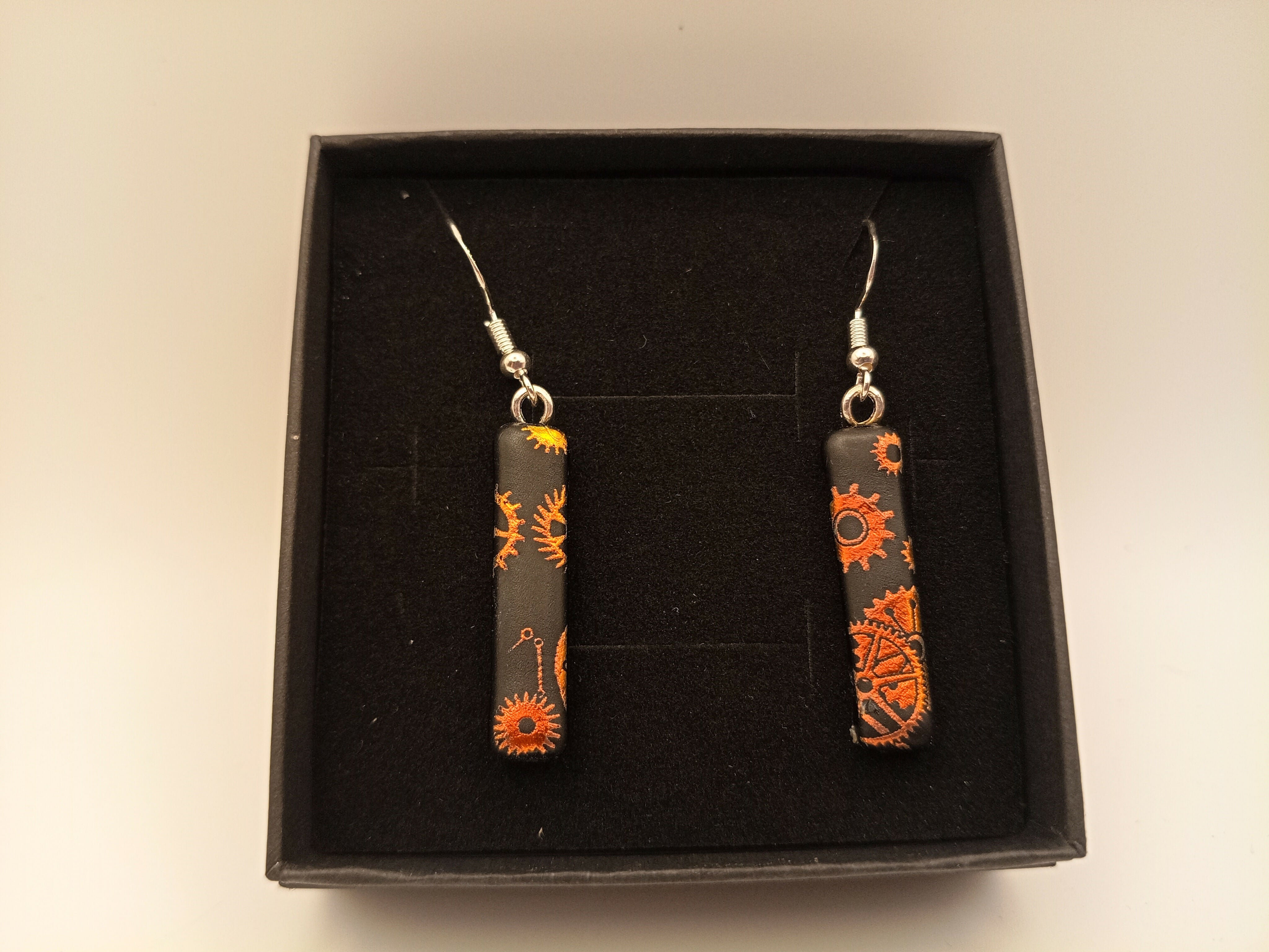 Orange Cogs on Black Earrings