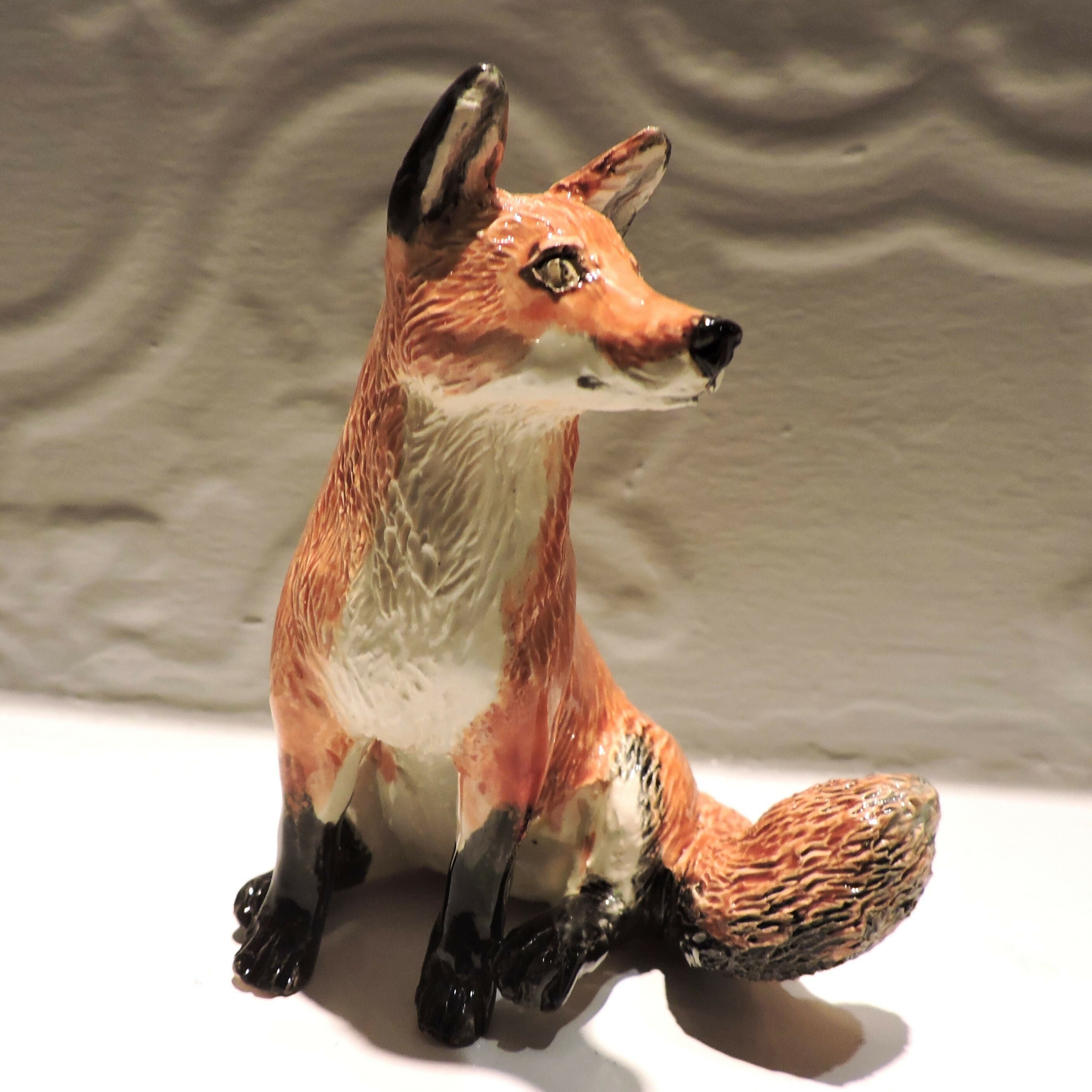 Ceramic sitting fox sculpture
