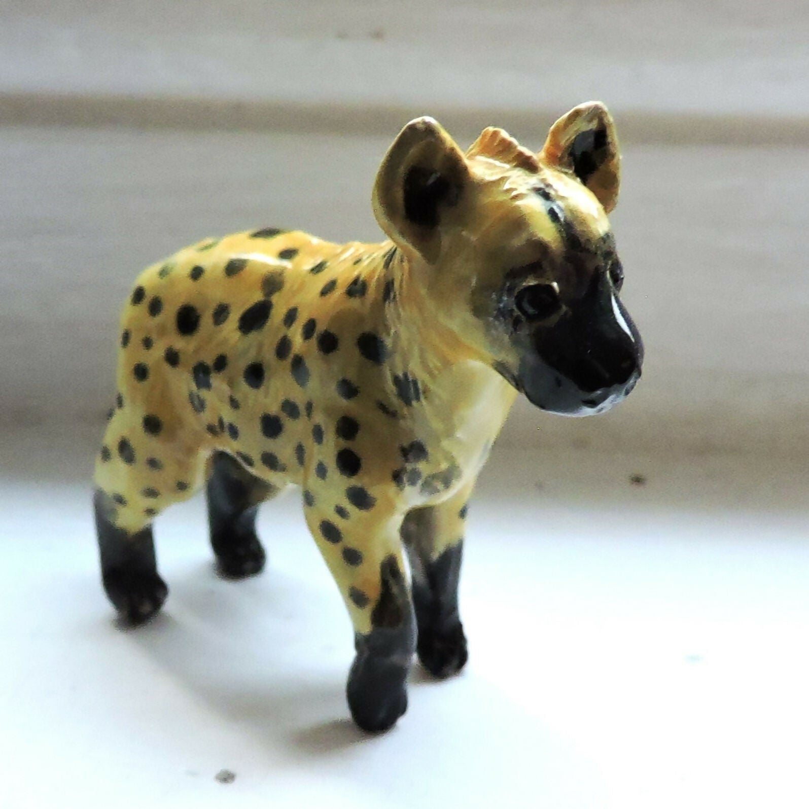 Ceramic spotted hyena sculpture