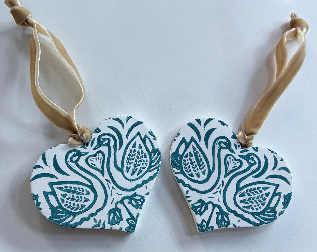 Hand-printed Wooden Heart Decoration with a Turquoise Swan Design.
