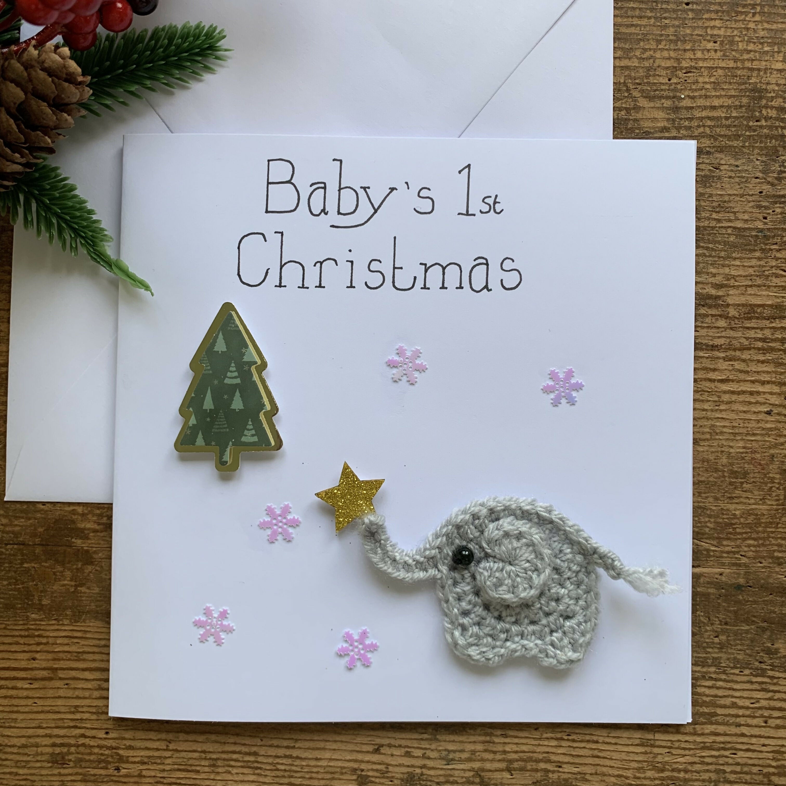 Christmas Card with Crocheted Elephant Putting Star on the Christmas tree.