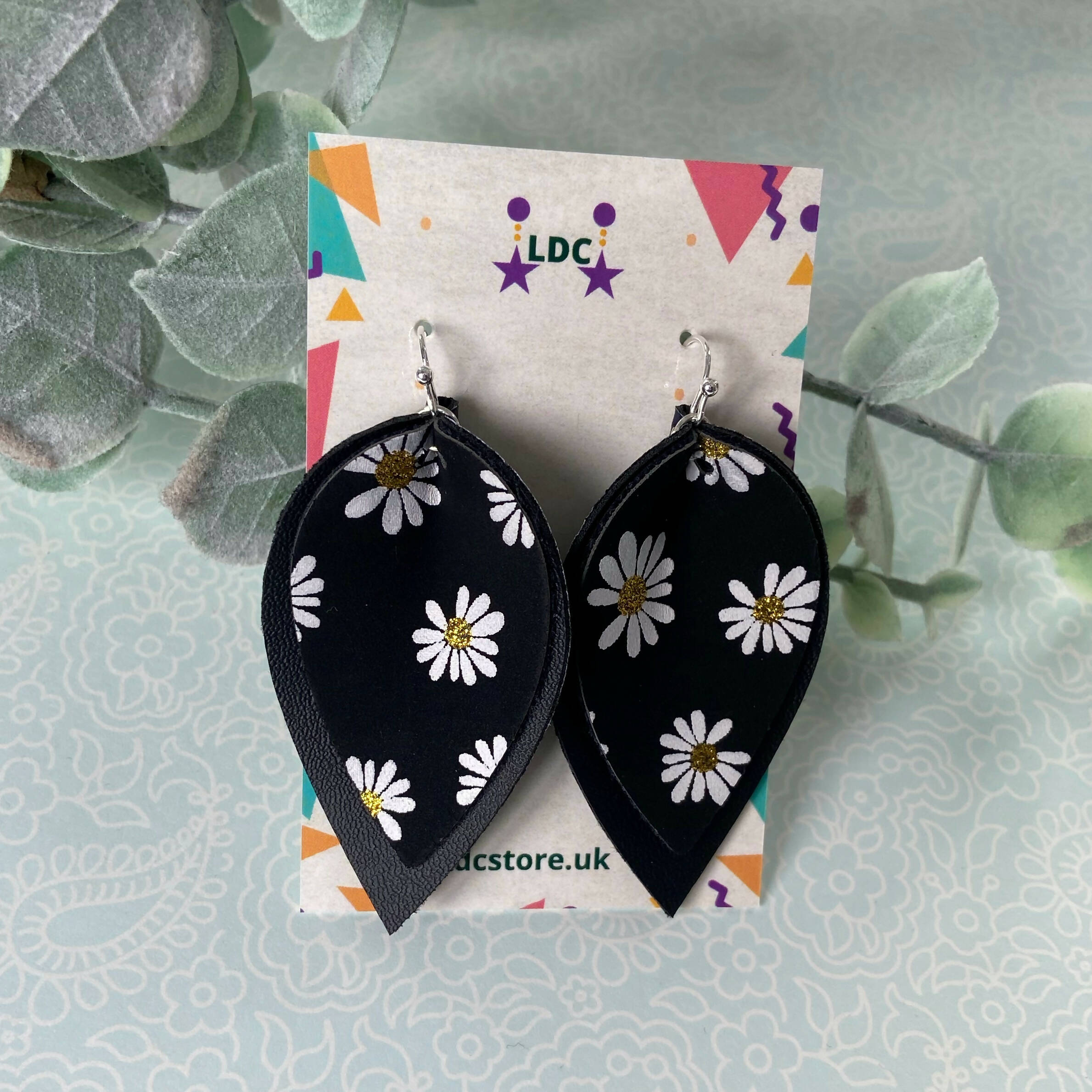 Daisy Print and Black Pinched Leaf Shaped Earrings in Faux Leather