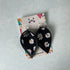 Daisy Print and Black Pinched Leaf Shaped Earrings in Faux Leather
