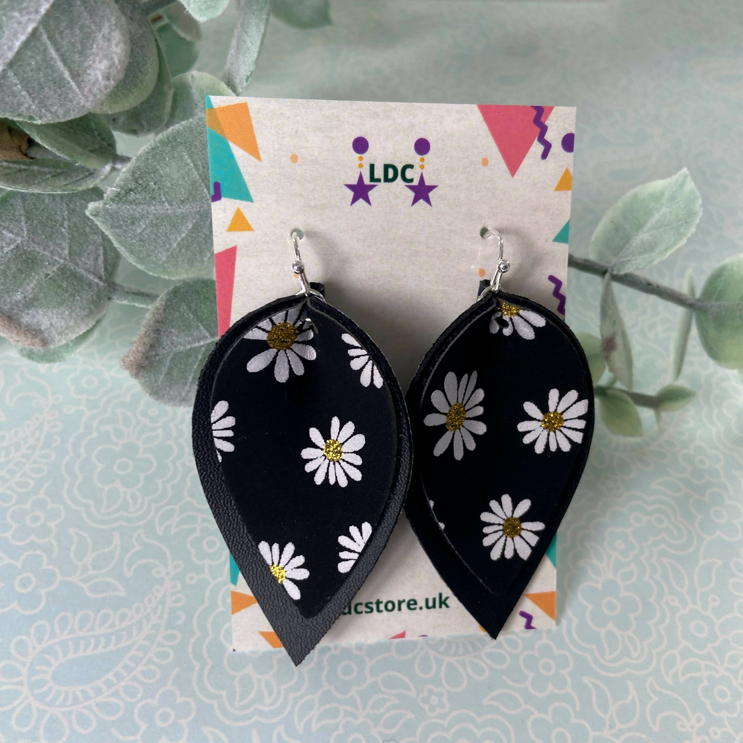 Daisy Print and Black Pinched Leaf Shaped Earrings in Faux Leather