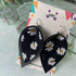 Daisy Print and Black Pinched Leaf Shaped Earrings in Faux Leather