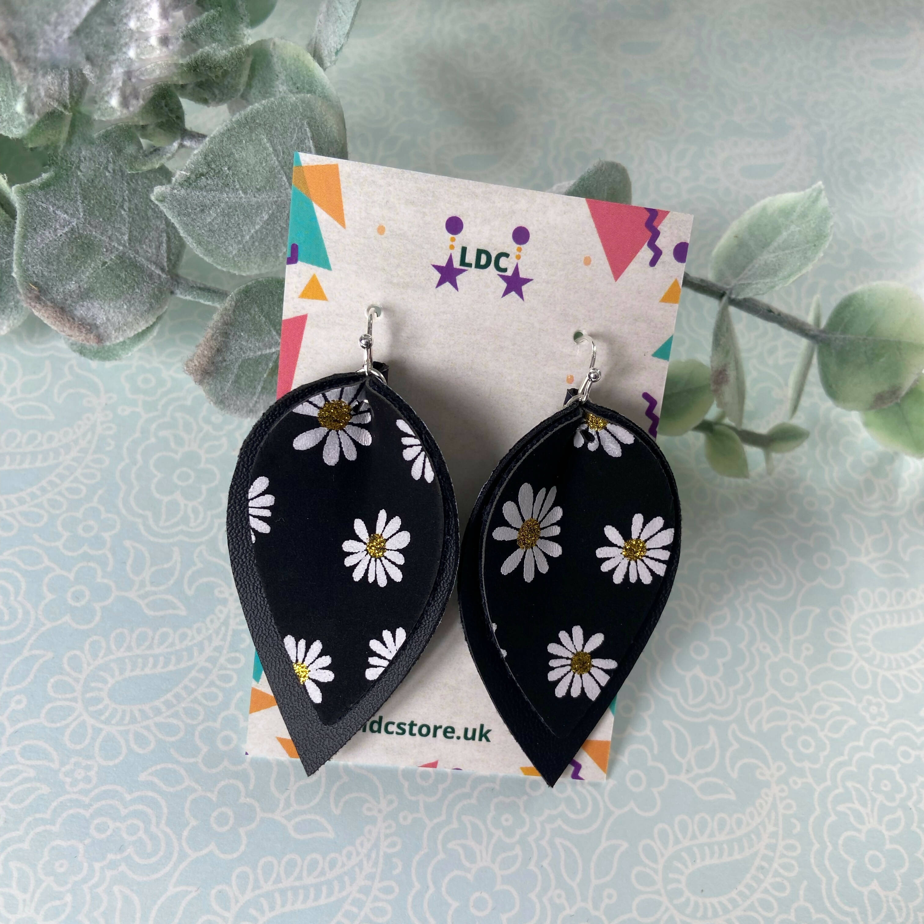 Daisy Print and Black Pinched Leaf Shaped Earrings in Faux Leather