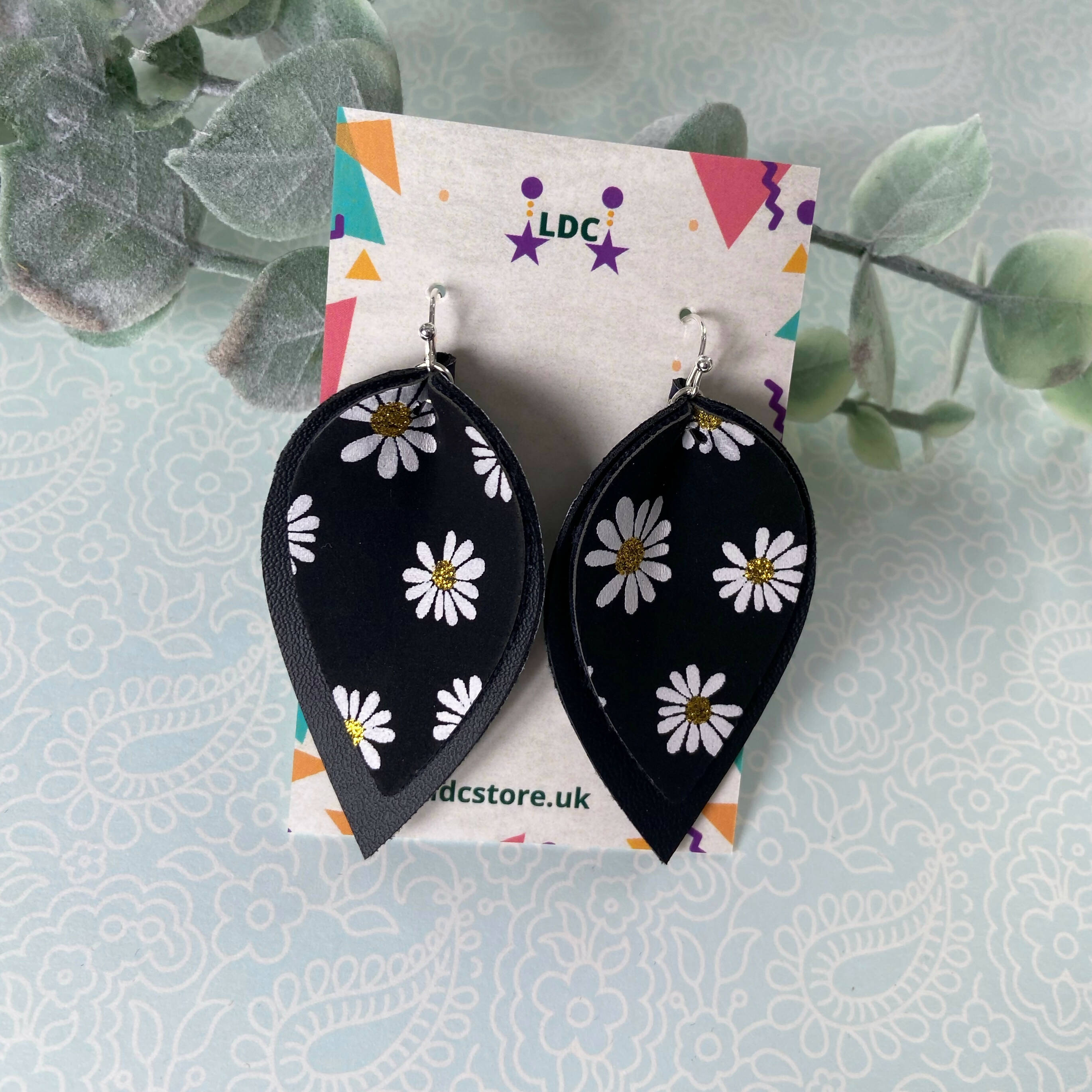 Daisy Print and Black Pinched Leaf Shaped Earrings in Faux Leather